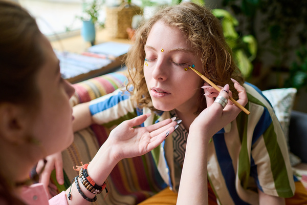 Girl Applies Rhinestone Makeup to Her Friend